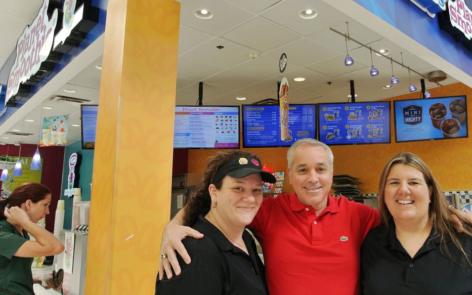 Craig Accardo poses with employees at his co-branded Planet Smoothie franchise location in Sanford, Florida.