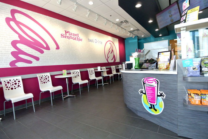 A planet smoothie franchise location with bright white chairs 
