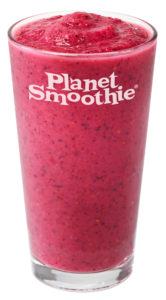 A bright pink smoothie against a pink backdrop