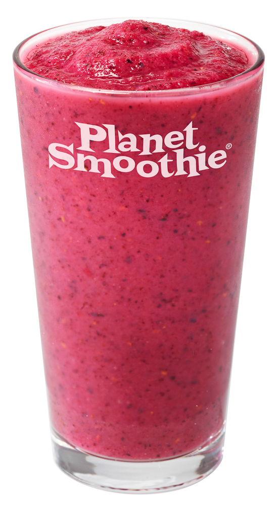 a bright fuchsia planet smoothie smoothie in a clear glass has clear flakes of fresh berries and seeds 