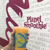 planet smoothie, smoothie in hand